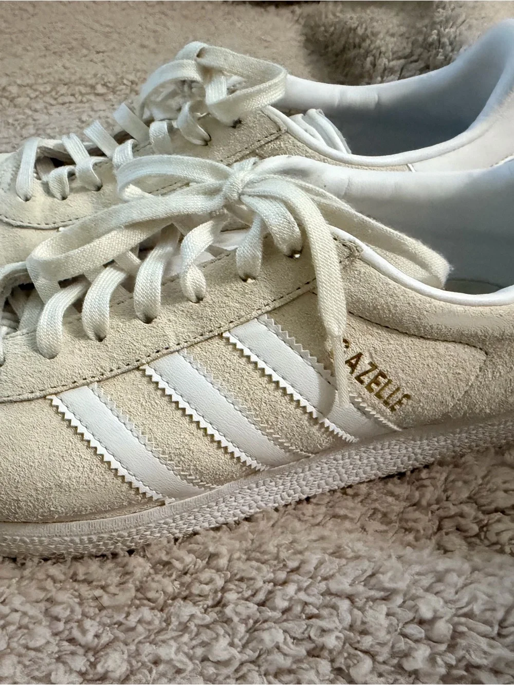 Women’s Adidas Gazelle sneakers in white/cream suede.